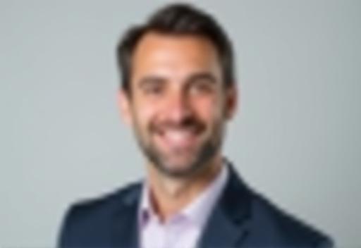 Professional headshot of a man smiling
