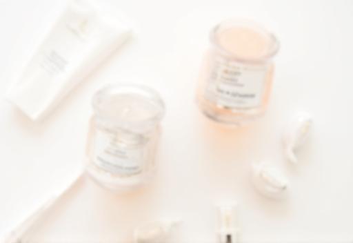 Arrangement of cosmetic products on a clean background